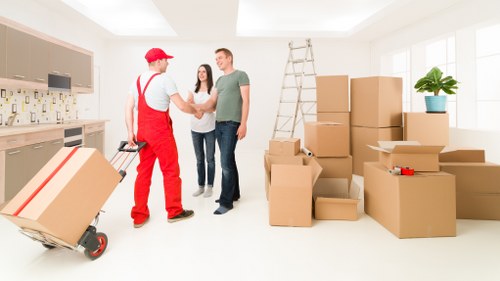 Mover wearing PPE while lifting furniture safely