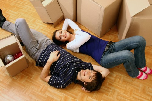 Professional movers handling furniture during an urgent Holloway relocation